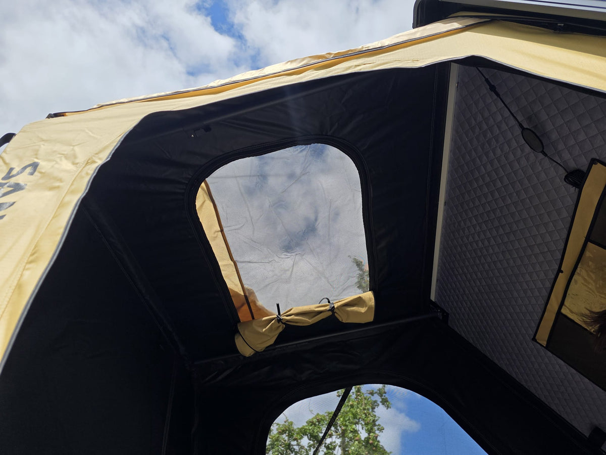 Interior of the LCM Offroad Savannah hardshell rooftop tent with mesh windows and quilted inner wall