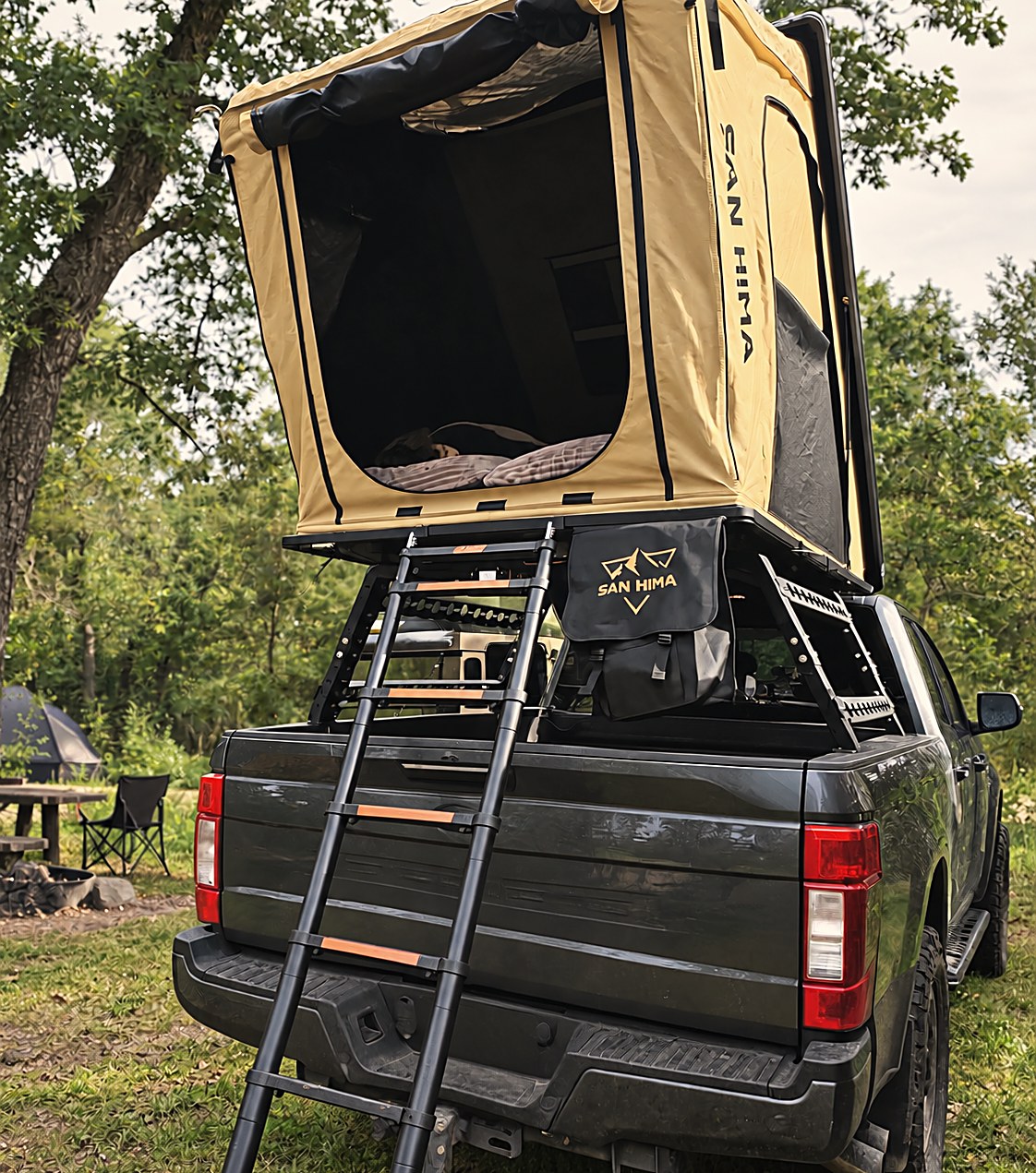 Kamperen met een LCM hardshell daktent op het bedrack van een Ford F-250 pick-up in het bos, ladder uitgeklapt
