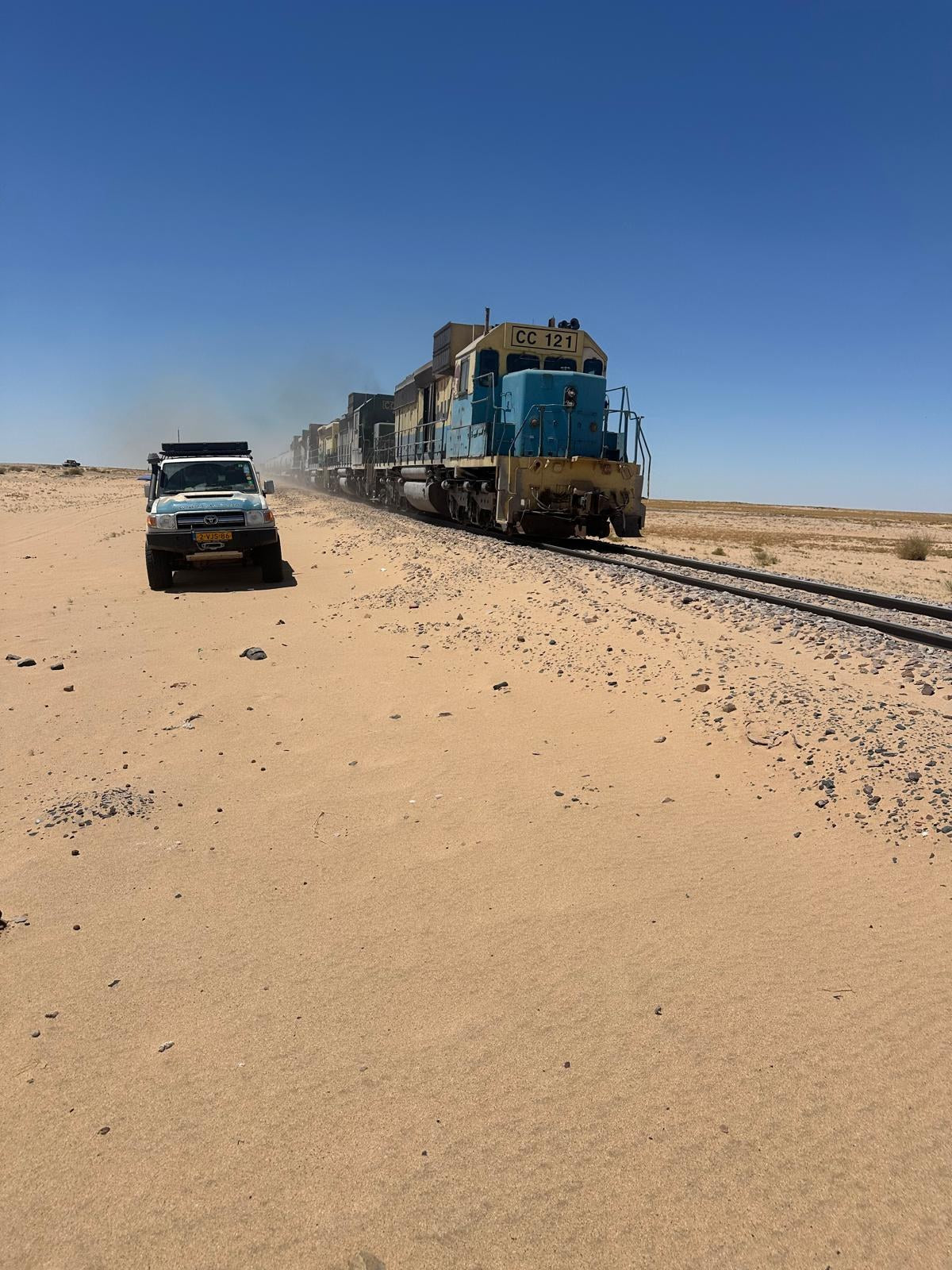 Land Cruiser with LCM rooftop tent next to the iron ore train in Mauritania
