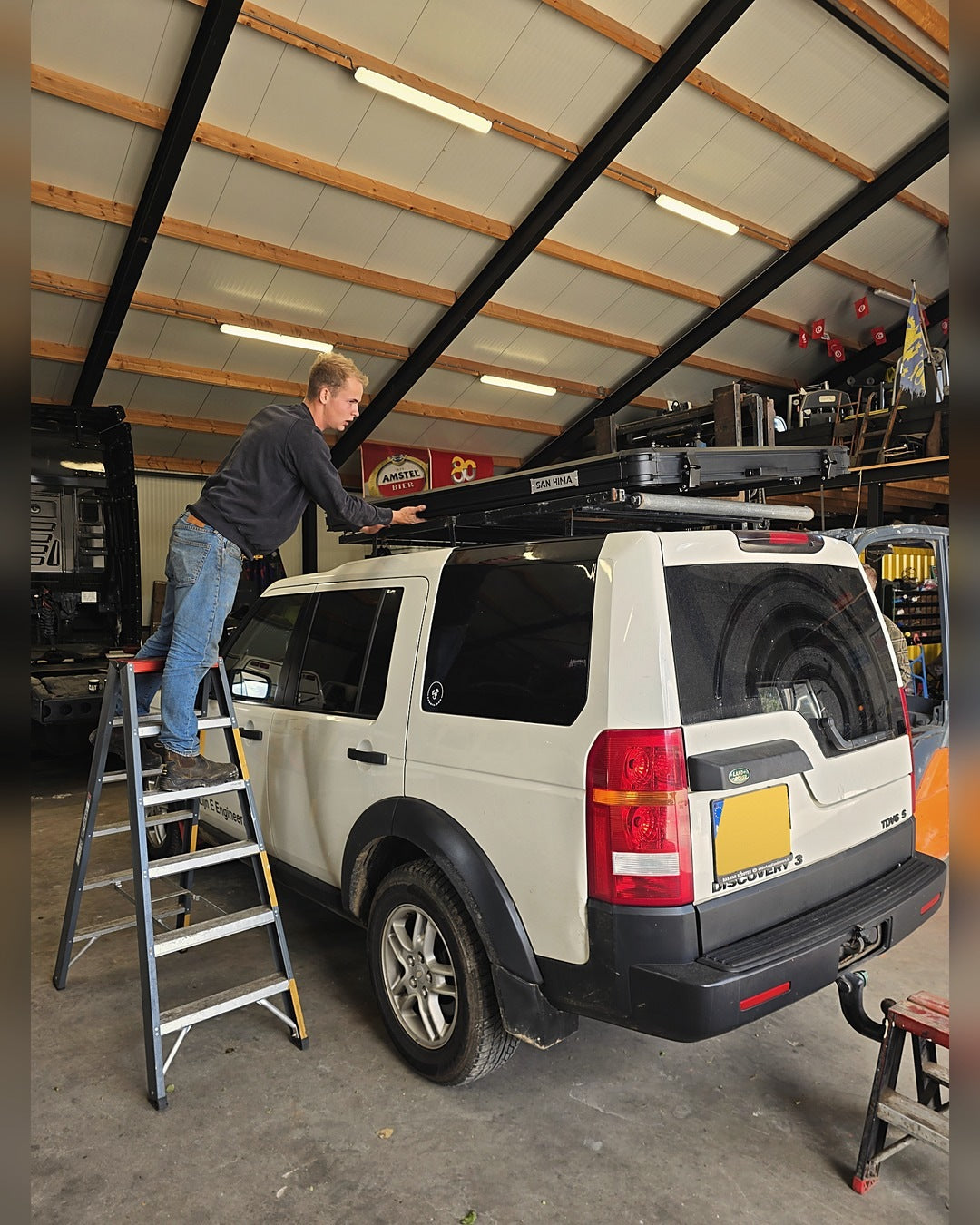 Fitting a hardshell rooftop tent to a Land Rover Discovery in the workshop